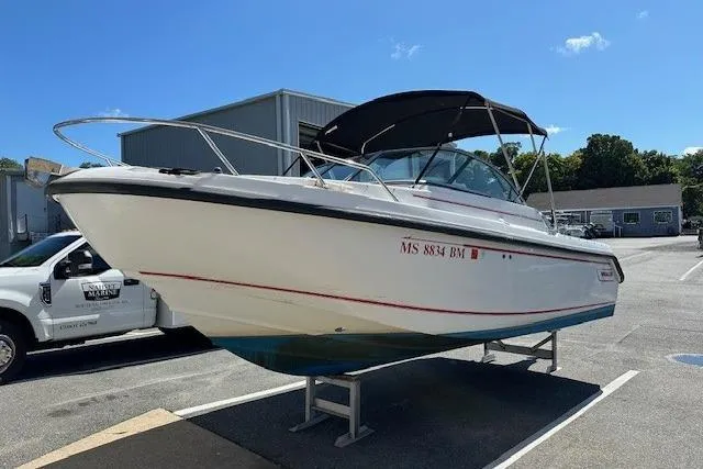 Slide: The Image of 2005 Boston Whaler VENTURA 210 boat on display in a parking lot. - 2