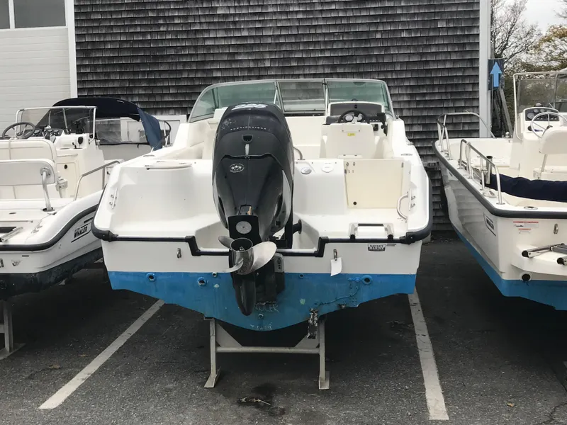Slide: The Image of 2005 Boston Whaler VENTURA 210 boat displayed in parking lot. - 5