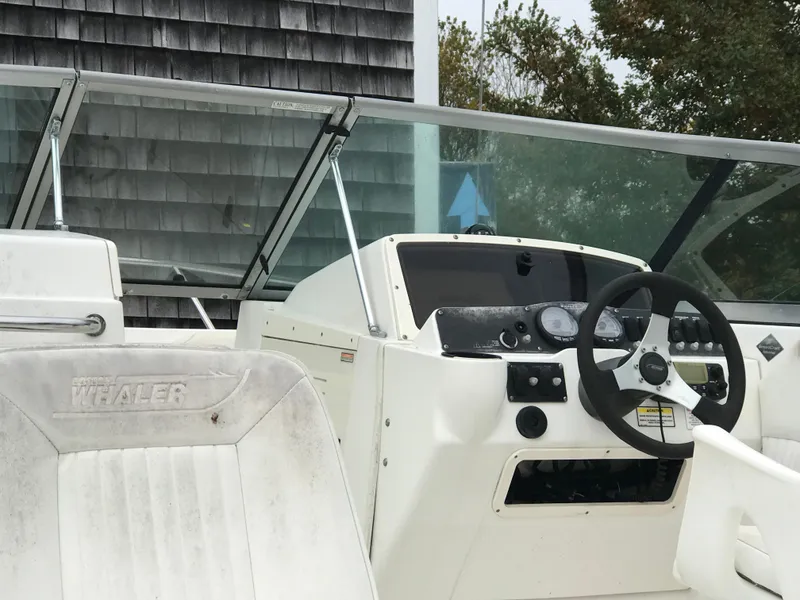 Slide: The Image of 2005 Boston Whaler VENTURA 210 boat helm and seating area. - 7