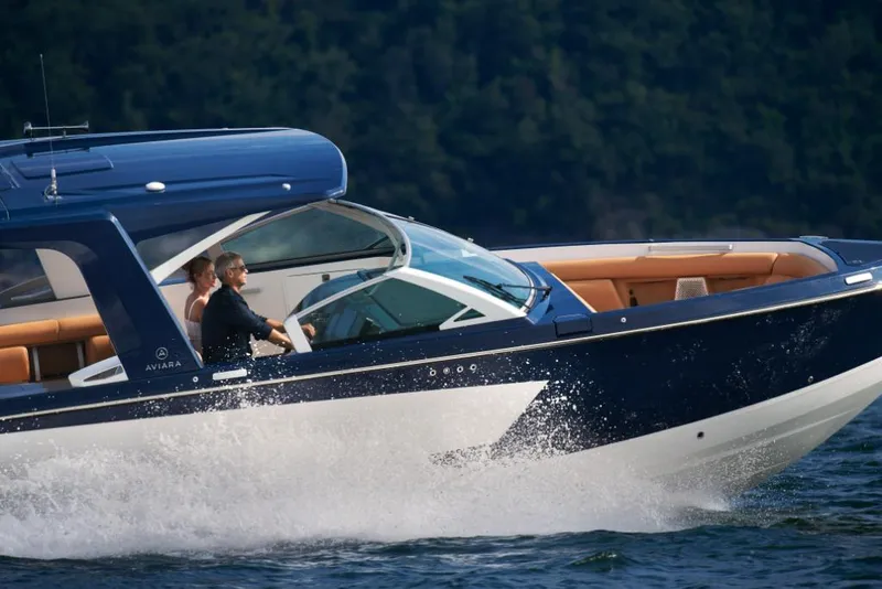 Slide: The Image of 2023 Aviara AV36 luxury boat cruising on water. - 22