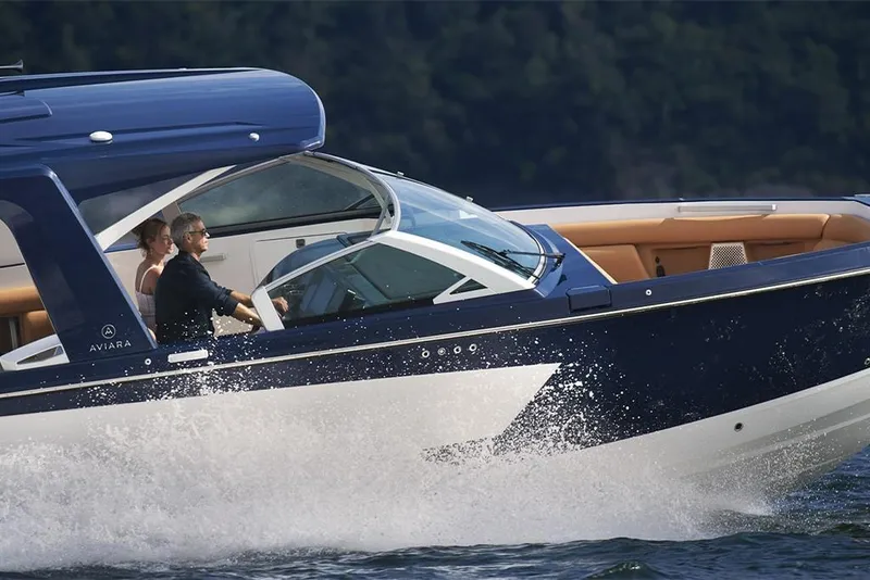 Slide: The Image of 2023 Aviara AV36 luxury boat cruising on water with passengers. - 3