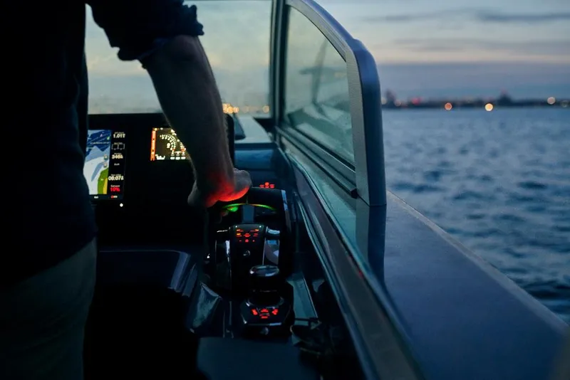 Slide: The Image of Person steering 2023 Aviara AV36 boat at dusk on open water. - 30