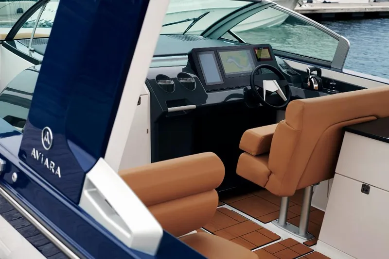 Slide: The Image of 2023 Aviara AV36 boat interior with modern dashboard and tan leather seats. - 6