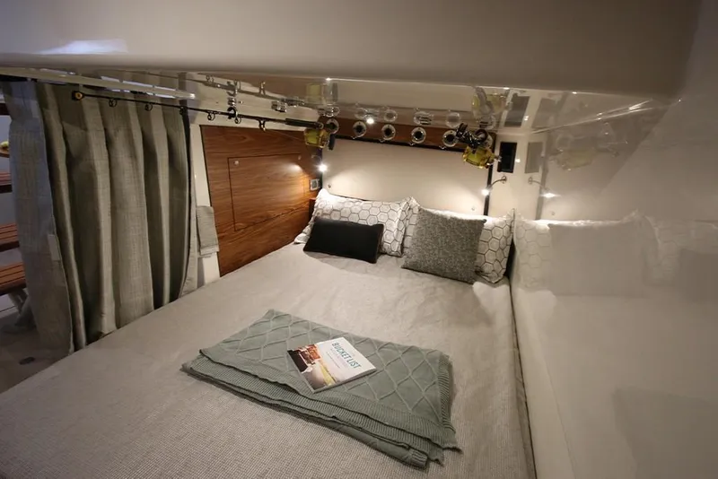 Slide: The Image of 2023 Boston Whaler 405 Conquest cabin with cozy bed and fishing rod holders. - 13