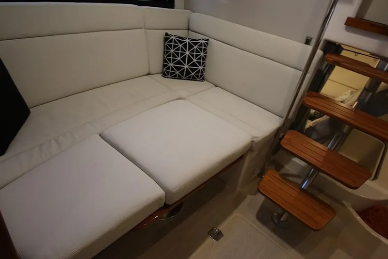 Slide: The Image of Interior seating area of 2023 Boston Whaler 405 Conquest with white cushions and decorative pillow. - 27