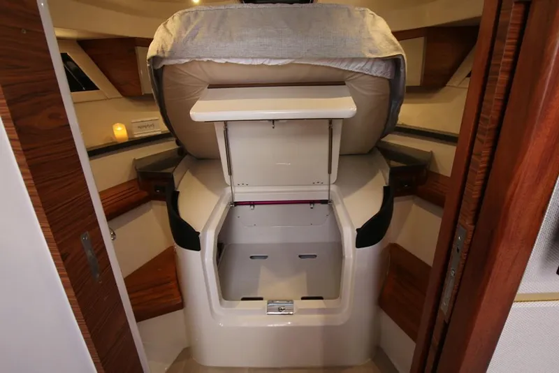 Slide: The Image of 2023 Boston Whaler 405 Conquest cabin interior with storage compartment and wooden accents. - 33