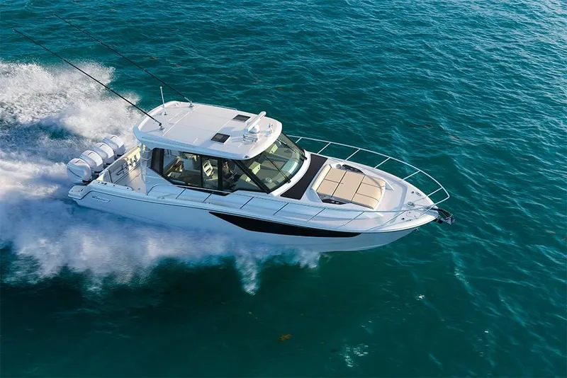Slide: The Image of 2023 Boston Whaler 405 Conquest cruising on open water. - 4