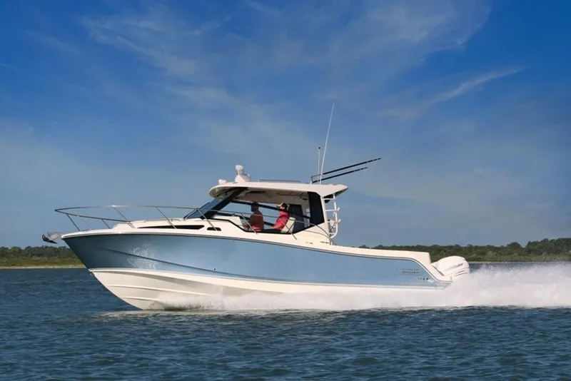 Slide: The Image of 2023 Boston Whaler 325 Conquest cruising on open water. - 0