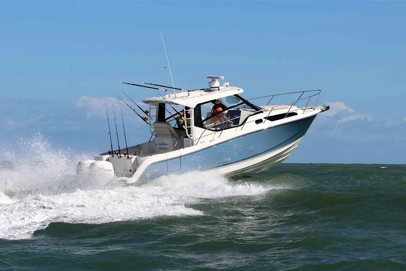Slide: The Image of 2023 Boston Whaler 325 Conquest cruising on open water. - 1