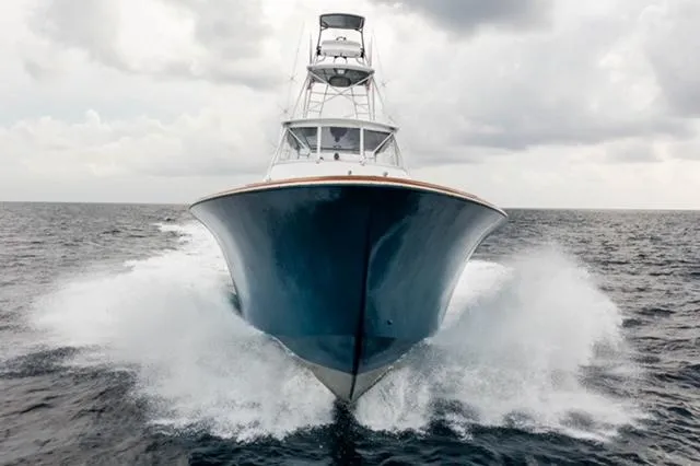 Slide: The Image of Jim Smith Custom 66 Sportfish 1999 cruising on open water, front view. - 4