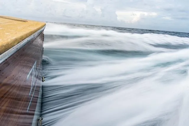 Slide: The Image of Jim Smith Custom 66 Sportfish slicing through ocean waves, 1999 model. - 9