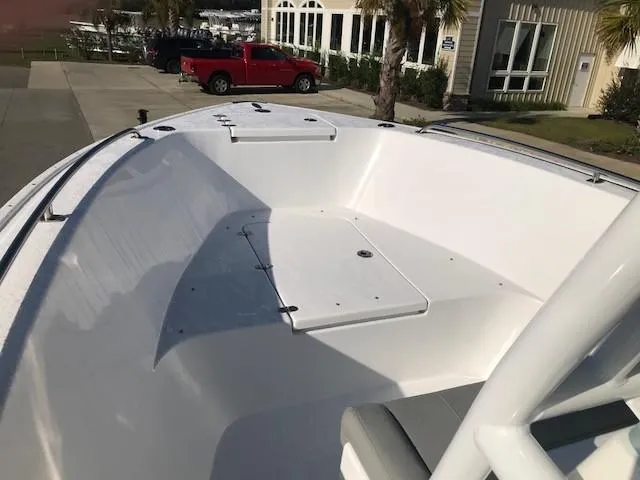 Slide: The Image of 2024 Cape Horn 22 boat deck with storage compartments and seating. - 5