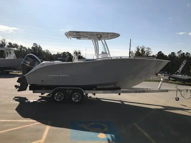 Slide: The Image of 2024 Cape Horn 22 boat on a trailer in a parking lot. - 2