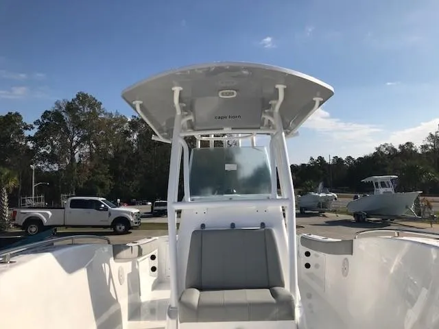 Slide: The Image of 2024 Cape Horn 22 boat with T-top and seating, parked outdoors. - 4
