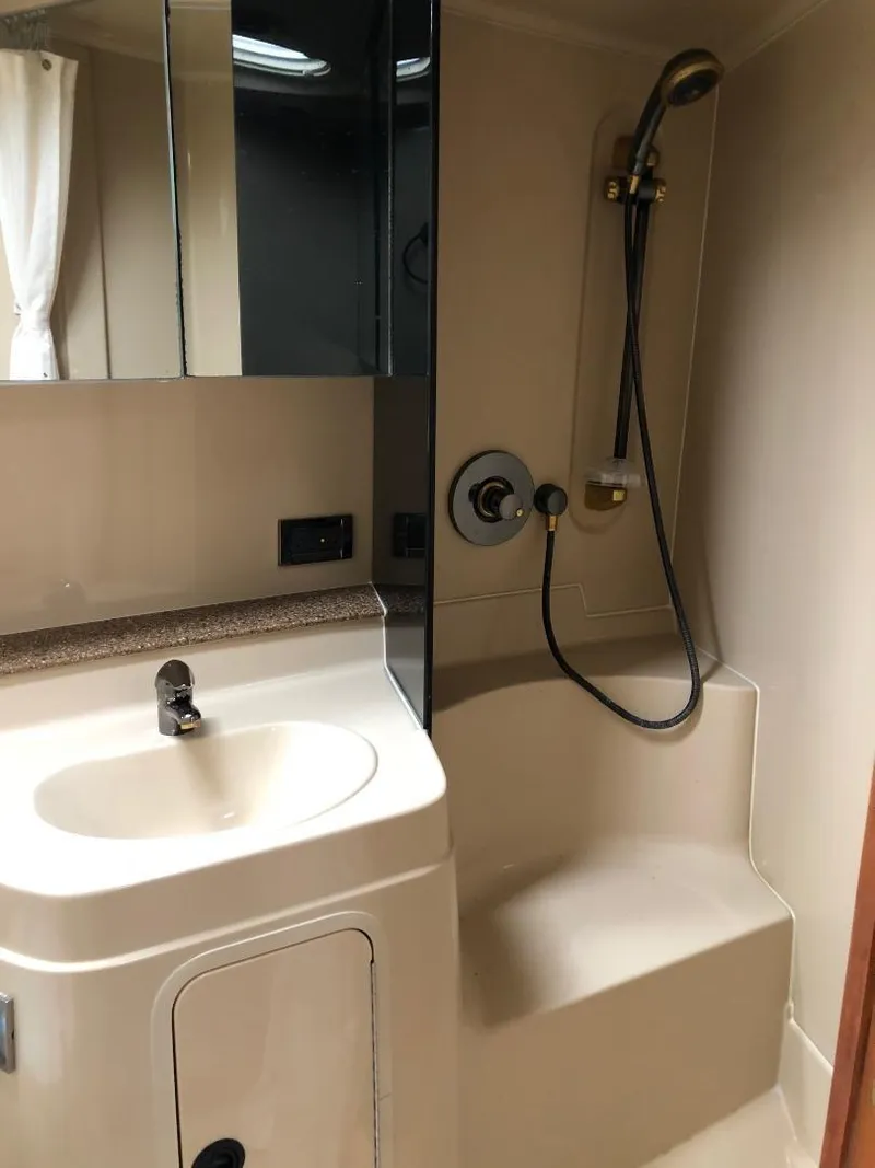 Slide: The Image of 2001 Cruisers Yachts 3470 Express bathroom with sink and shower. - 24