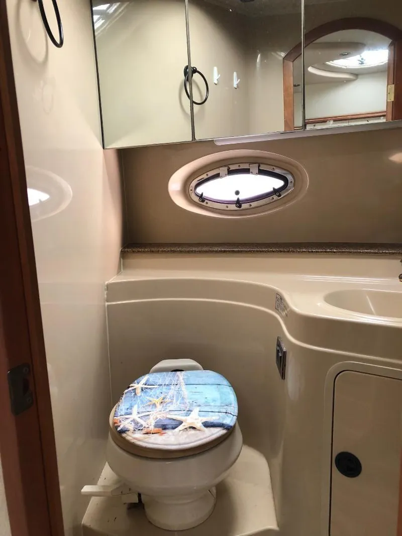 Slide: The Image of 2001 Cruisers Yachts 3470 Express bathroom with nautical-themed toilet seat. - 25