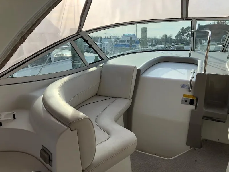 Slide: The Image of 2001 Cruisers Yachts 3470 Express interior with curved seating and large windows. - 7
