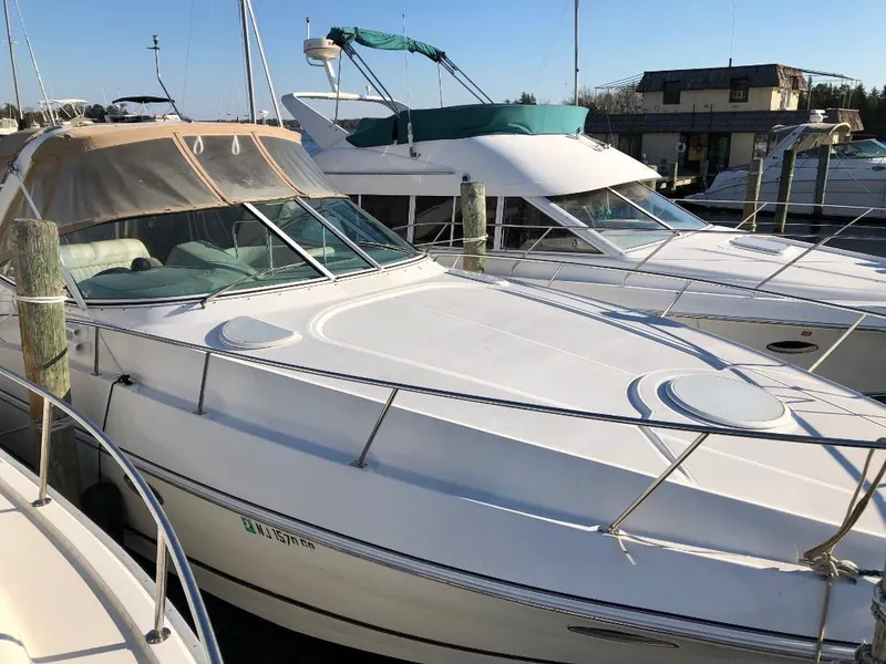 Slide: The Image of 2001 Cruisers Yachts 3470 Express docked at marina, showcasing sleek design and spacious deck. - 1