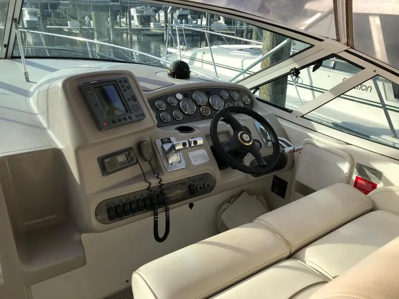 Slide: The Image of 2001 Cruisers Yachts 3470 Express helm with navigation instruments and steering wheel. - 10
