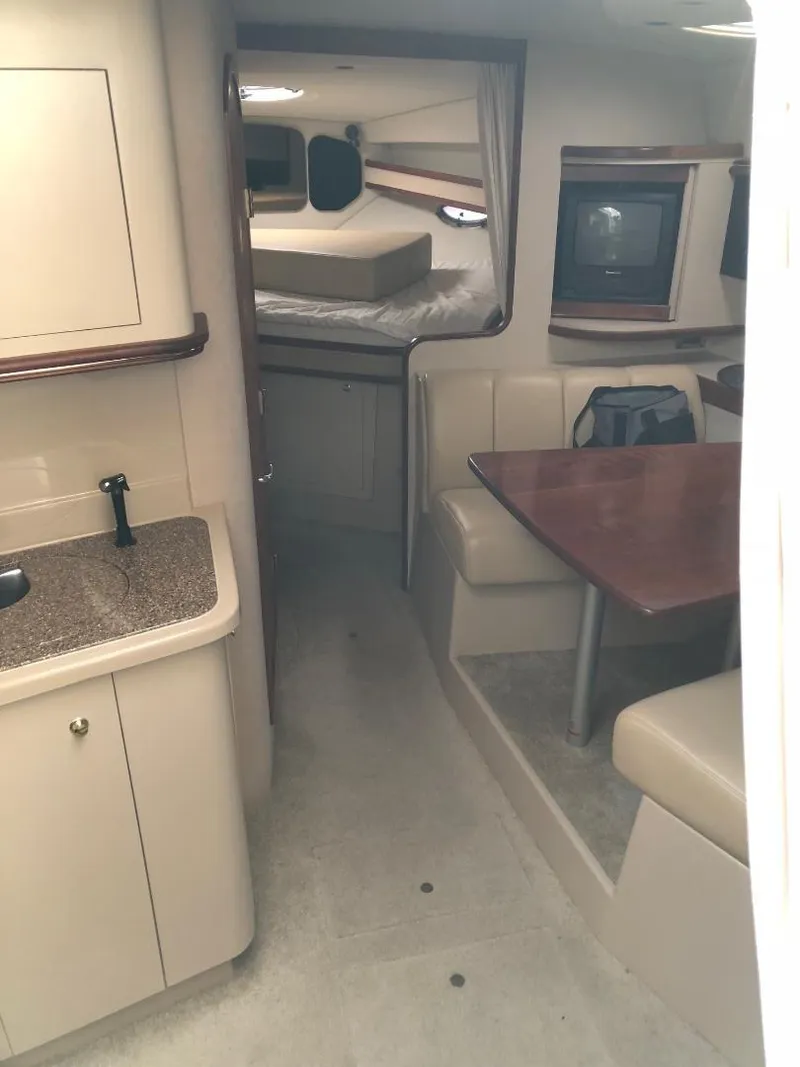 Slide: The Image of 2001 Cruisers Yachts 3470 Express interior with kitchen, dining area, and sleeping quarters. - 13