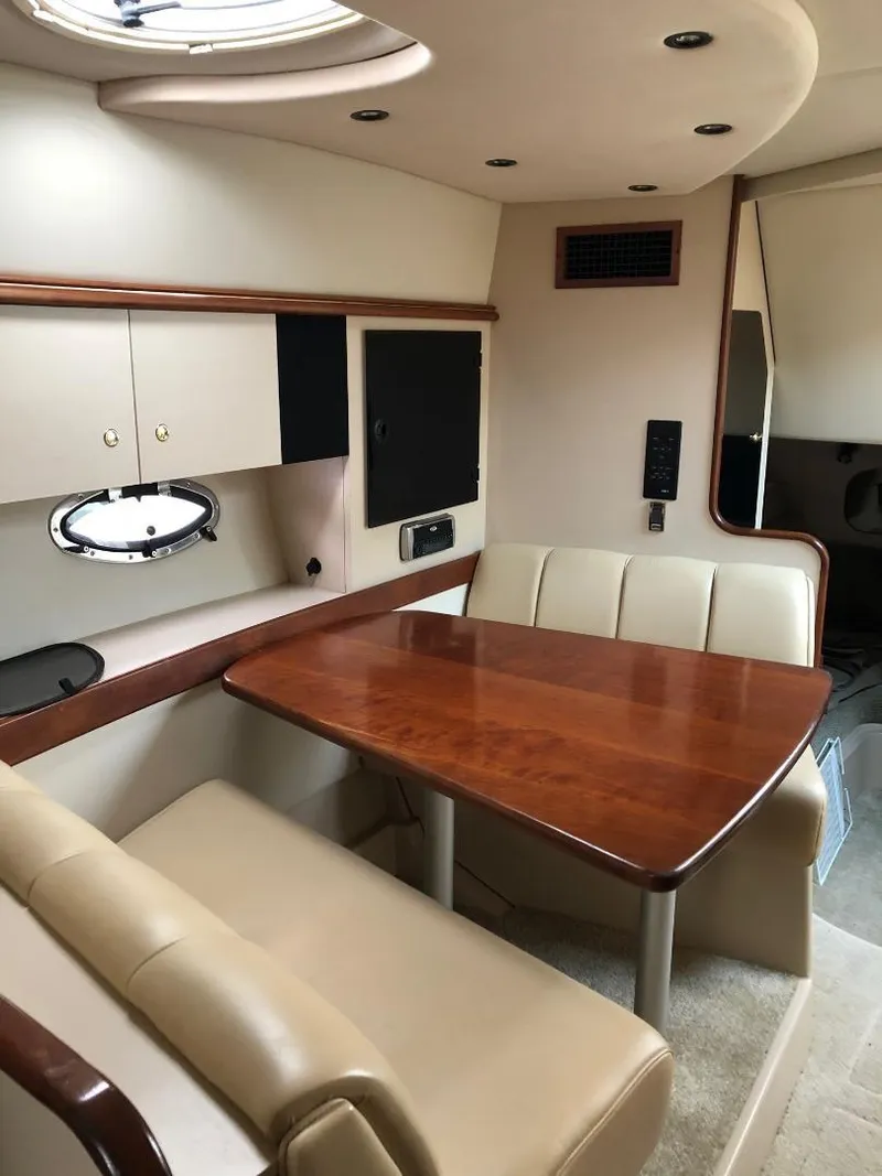 Slide: The Image of 2001 Cruisers Yachts 3470 Express interior with dining area and seating. - 21