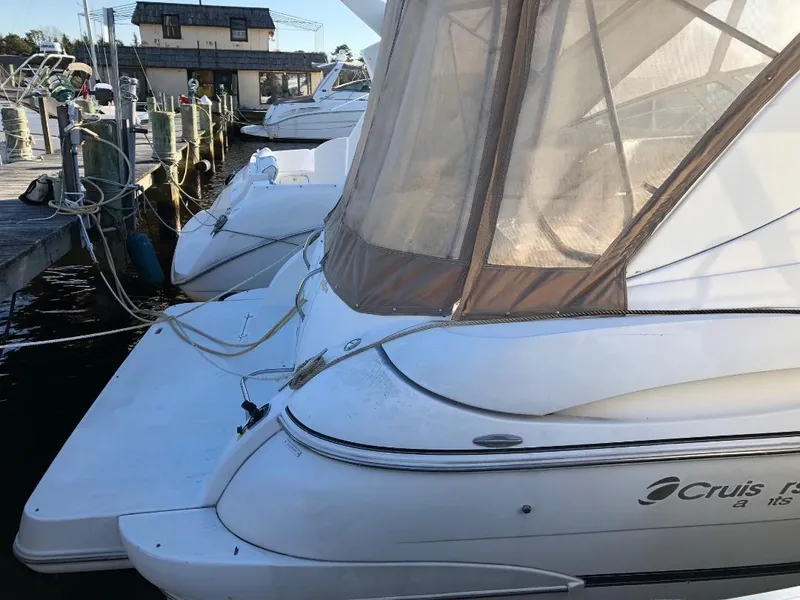 Slide: The Image of 2001 Cruisers Yachts 3470 Express docked at marina, featuring sleek design and covered cockpit. - 5
