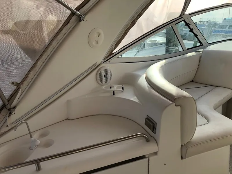 Slide: The Image of 2001 Cruisers Yachts 3470 Express interior with white seating and sleek design. - 6