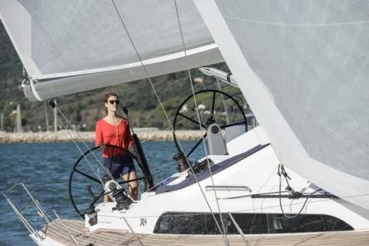Slide: The Image of Woman sailing 2025 X-Yachts X4.3 yacht on open water. - 1