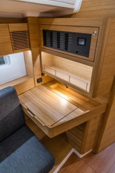 Slide: The Image of 2025 X-Yachts X4.3 interior with wooden desk and control panel. - 8