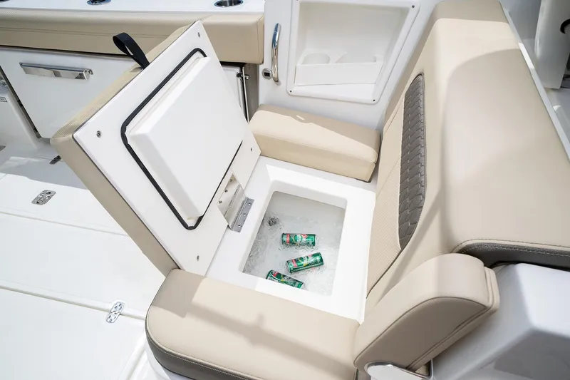 Slide: The Image of 2025 Pursuit DC 326 boat with built-in cooler and beige seating. - 10