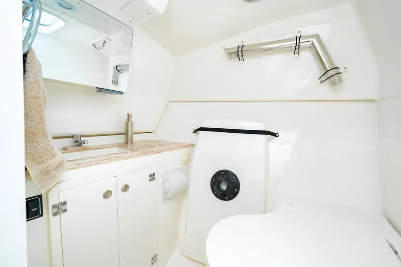 Slide: The Image of Modern bathroom in 2025 Pursuit DC 326 boat with sink, mirror, and toilet. - 12