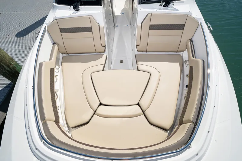 Slide: The Image of 2025 Pursuit DC 326 boat with spacious beige seating area. - 14