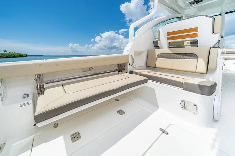 Slide: The Image of 2025 Pursuit DC 326 boat interior with luxurious seating and ocean view. - 25
