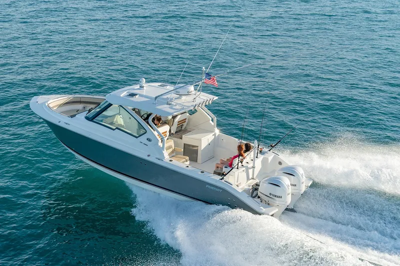 Slide: The Image of 2025 Pursuit DC 326 boat cruising on open water. - 3