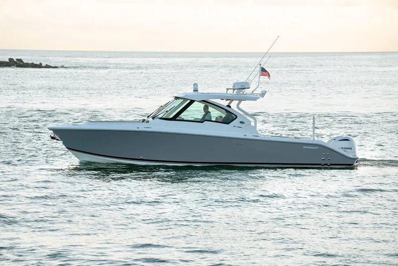 Slide: The Image of 2025 Pursuit DC 326 boat cruising on open water. - 5