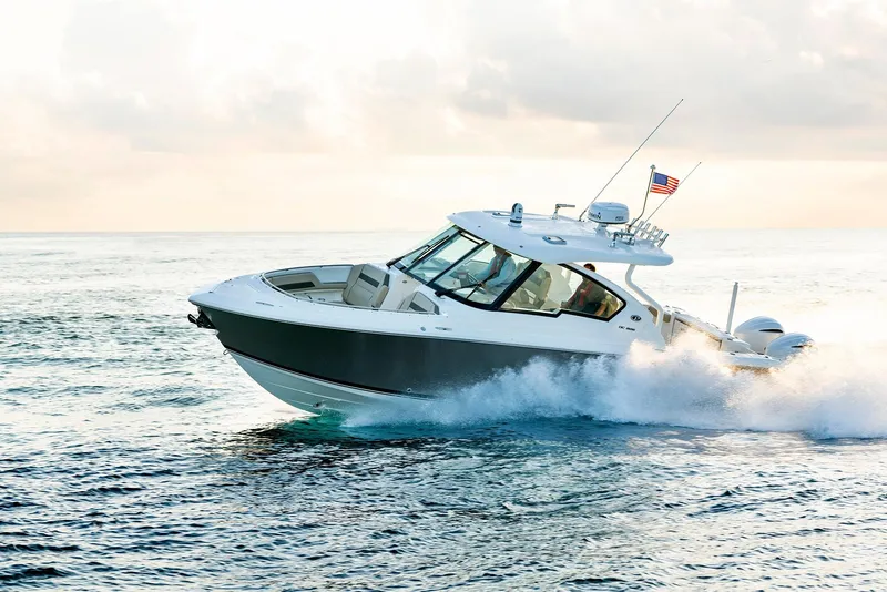 Slide: The Image of 2025 Pursuit DC 326 boat cruising on open water. - 7