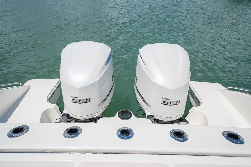 Slide: The Image of Twin outboard engines on a 2025 Pursuit DC 326 boat. - 9