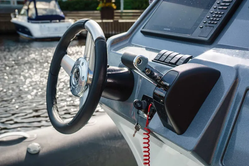 Slide: The Image of 2024 Grand Inflatables G850 boat steering console with controls and display. - 8
