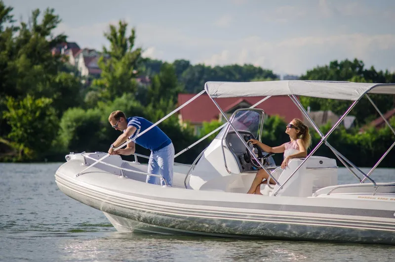 The Image of 2024 Grand Inflatables G650 boat on a lake with two people onboard. - 1