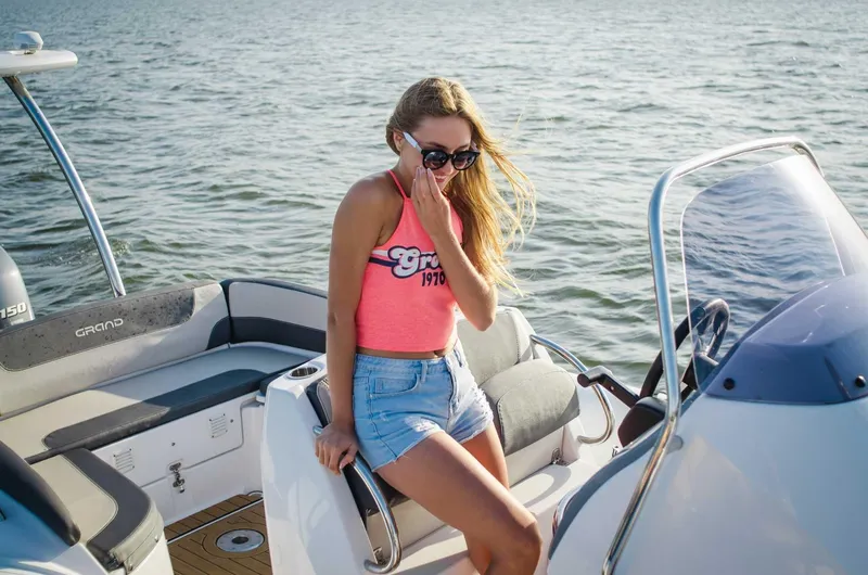 Slide: The Image of Woman enjoying a sunny day on a 2024 Grand Inflatables G650 boat. - 13