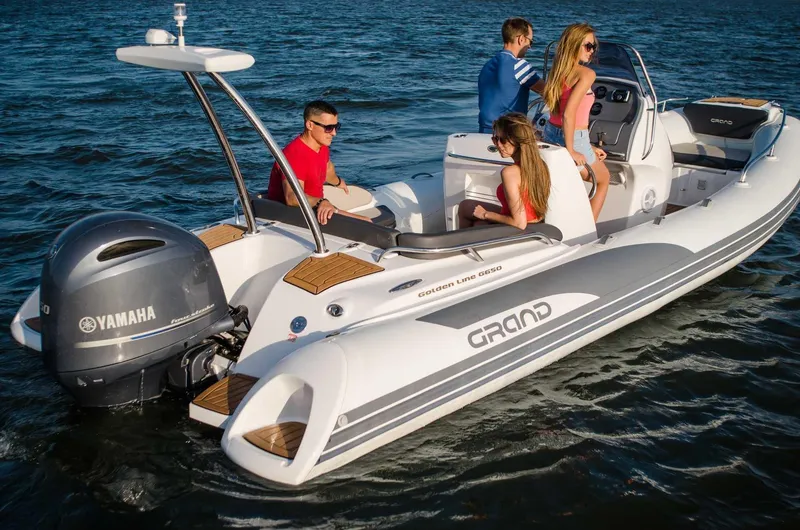 Slide: The Image of 2024 Grand Inflatables G650 boat with Yamaha engine on the water. - 14