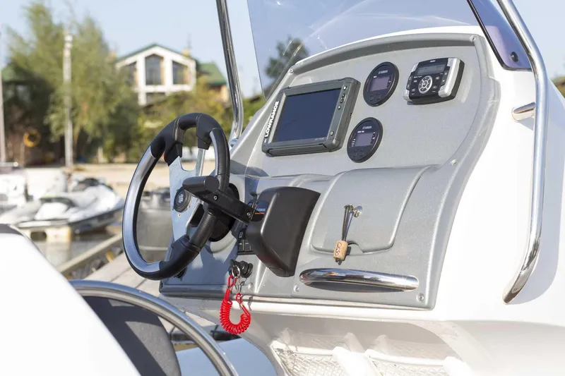 Slide: The Image of 2024 Grand Inflatables G650 boat dashboard with steering wheel and control panel. - 30