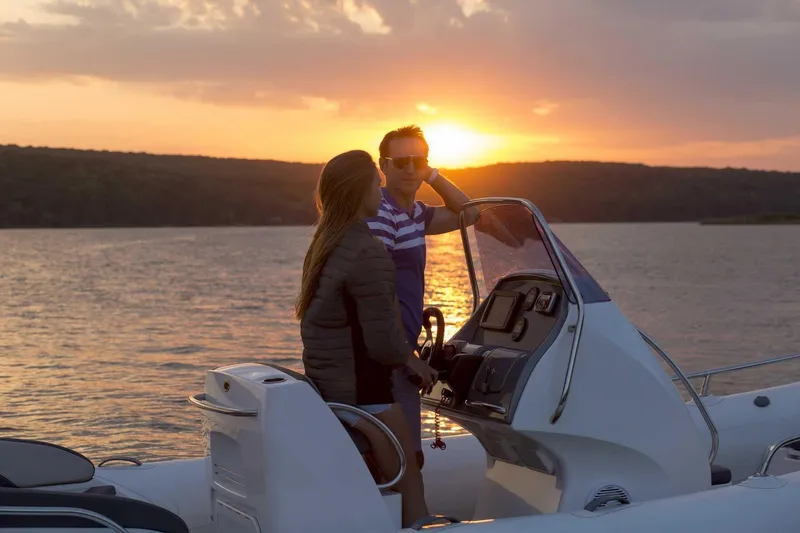 Slide: The Image of Couple enjoying sunset on 2024 Grand Inflatables G650 boat. - 31