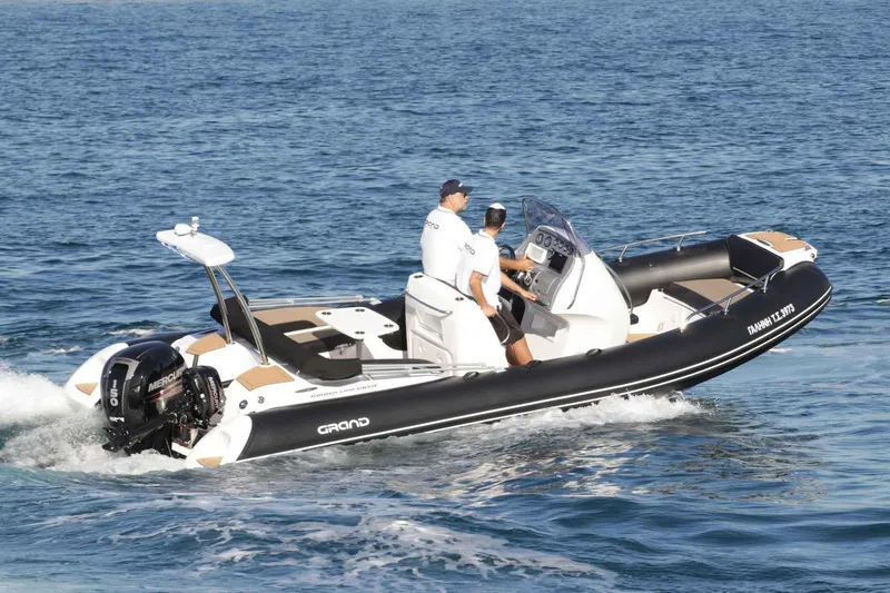 Slide: The Image of 2024 Grand Inflatables G650 boat cruising on the water. - 33
