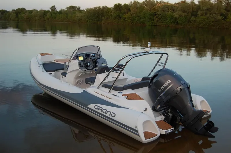 Slide: The Image of 2024 Grand Inflatables G580 boat with Yamaha engine on calm water. - 10