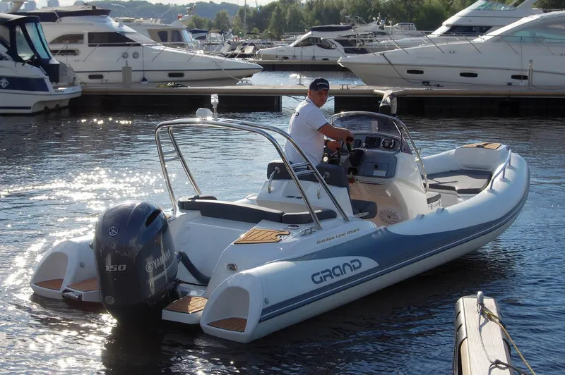 Slide: The Image of 2024 Grand Inflatables G580 boat with Yamaha outboard motor in marina. - 11