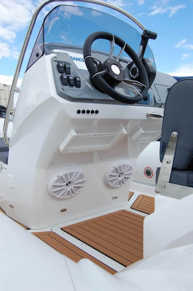 Slide: The Image of 2024 Grand Inflatables G580 boat console with steering wheel and controls. - 17
