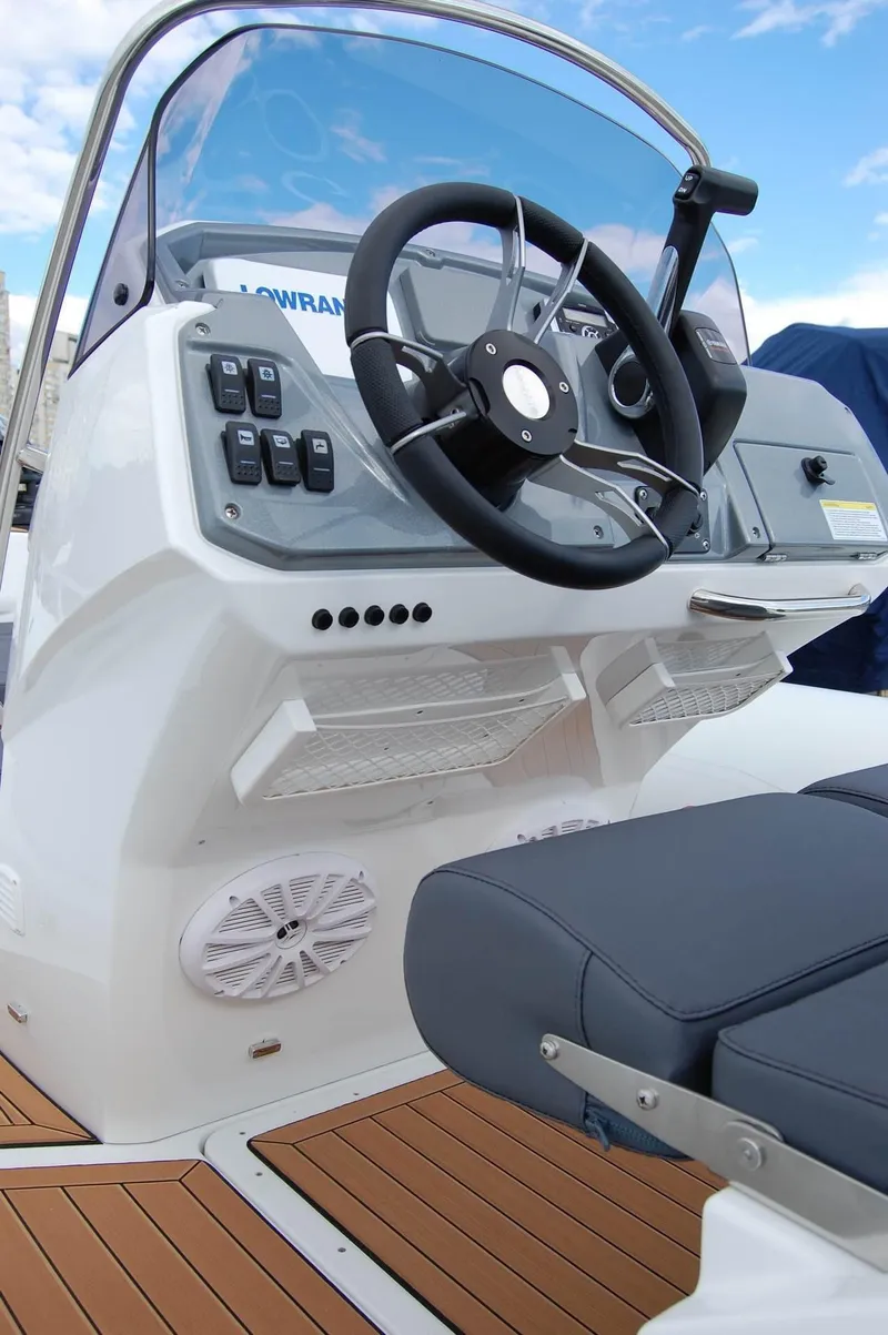 Slide: The Image of 2024 Grand Inflatables G580 boat console with steering wheel and controls. - 18