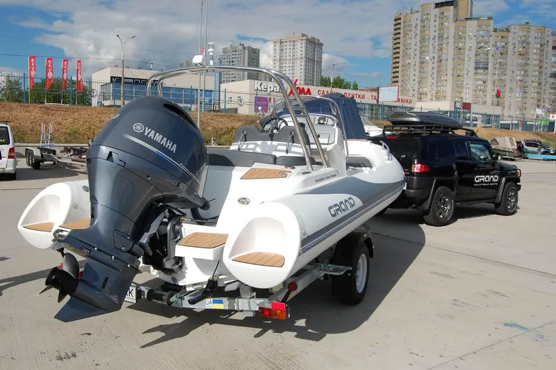 Slide: The Image of 2024 Grand Inflatables G580 boat with Yamaha engine on trailer in urban setting. - 20