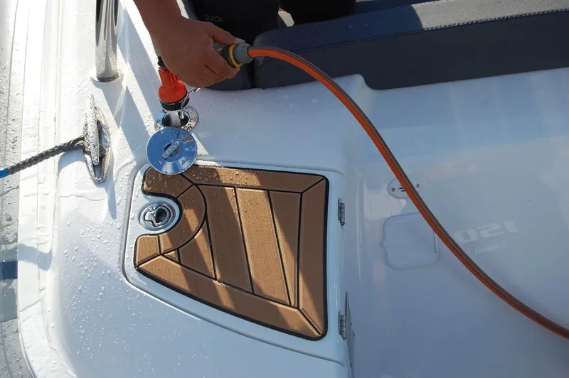 Slide: The Image of 2024 Grand Inflatables G580 boat deck with water hose and teak flooring. - 22